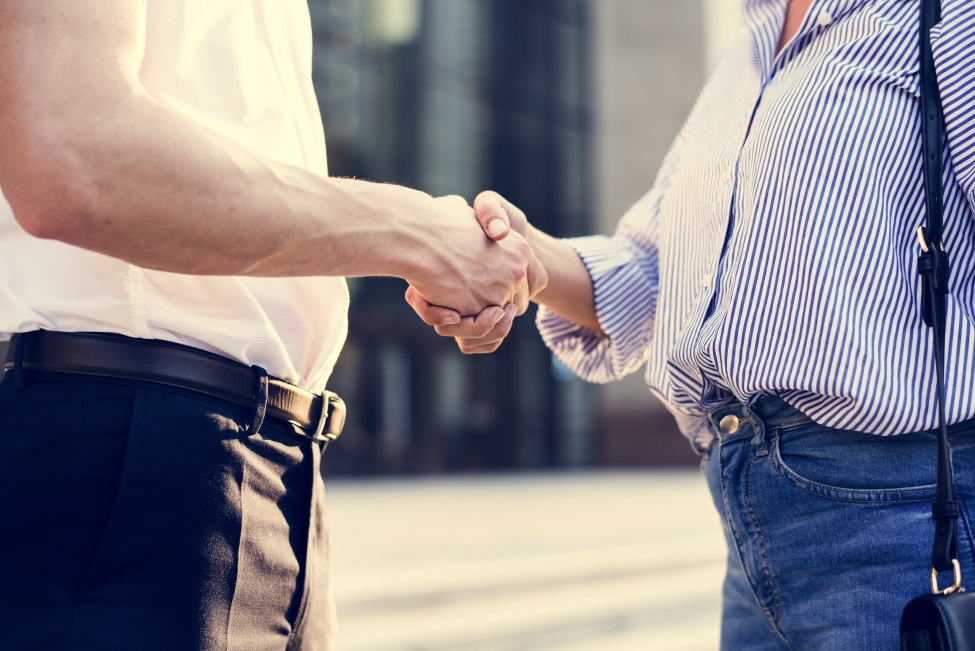 People greeting by shaking hands